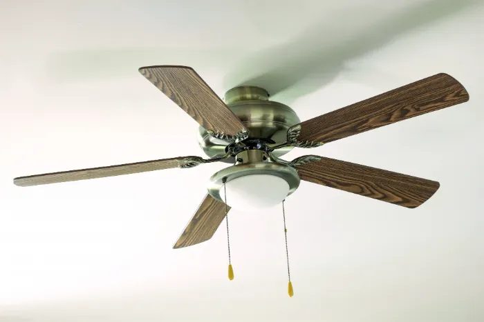 A ceiling fan is attached to the ceiling of a home.